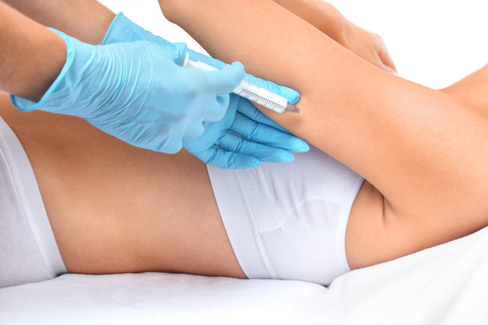 Fat-dissolving injections | A person having a fat-dissolving product injected into their underarm area.