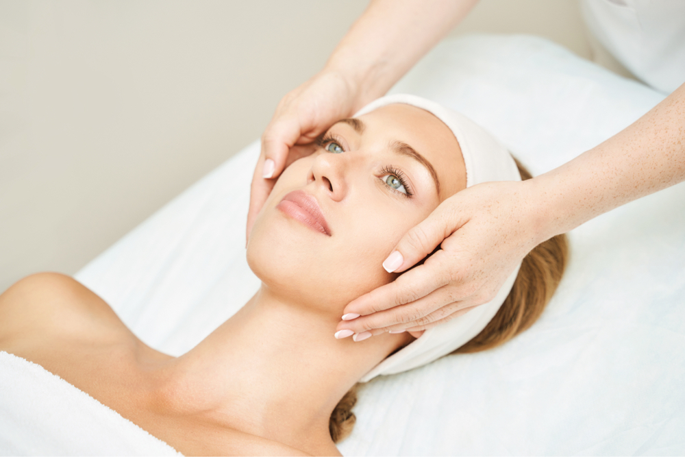 Chemical Peel | A white woman having her face massaged after a facial.