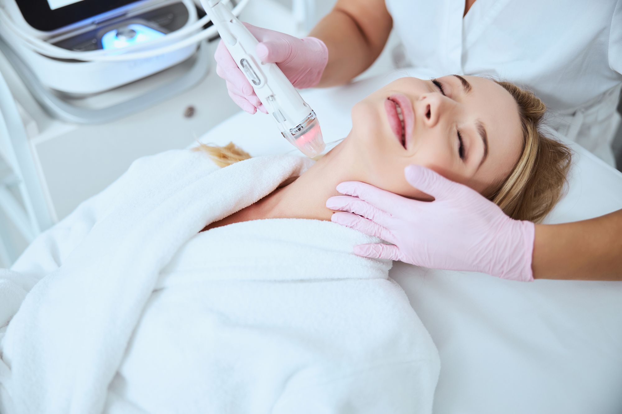 Microneedling | A woman receiving a microneedling treatment to her neck.