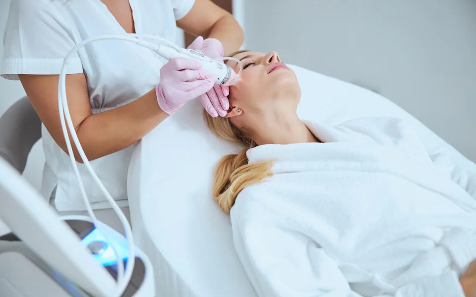 Microneedling | A woman receiving a microneedling treatment to her face.